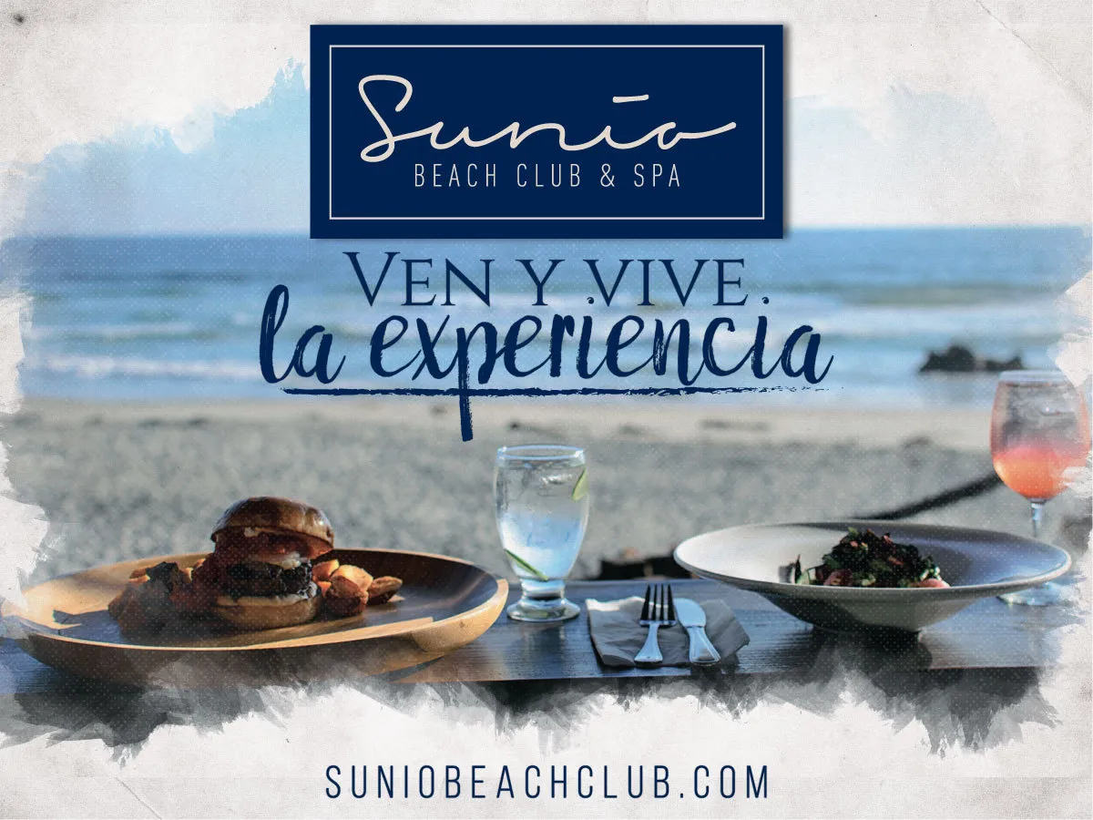 Sunio ad reading “Ven y vive la experiencia” over a table set by the sea